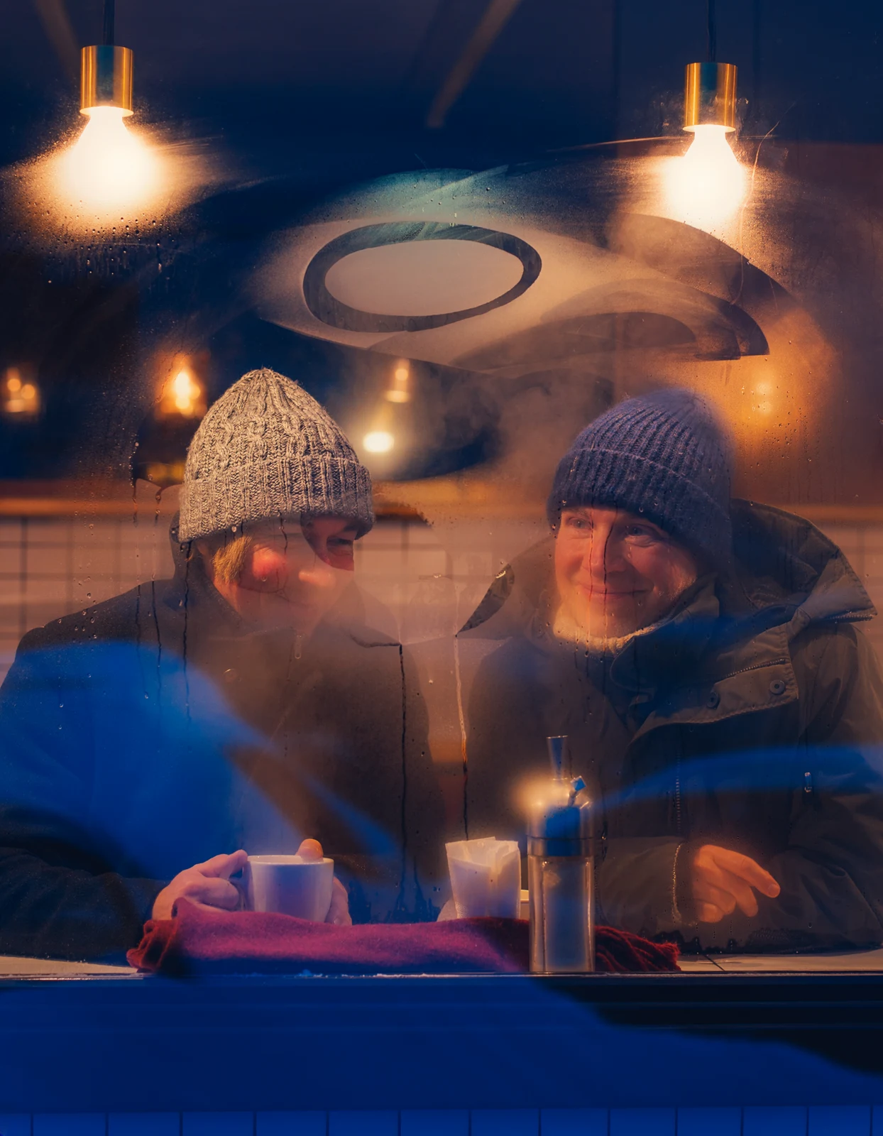 Warm indoor winter scene with a cup and a person at the table